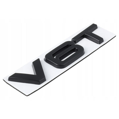 Emblema auto Audi V6T, 8,6x1,9 cm, neagra, din plastic, montare cu banda dublu adeziva